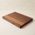 Walnut and cherry edge grain cutting board, 16 by 11 inches