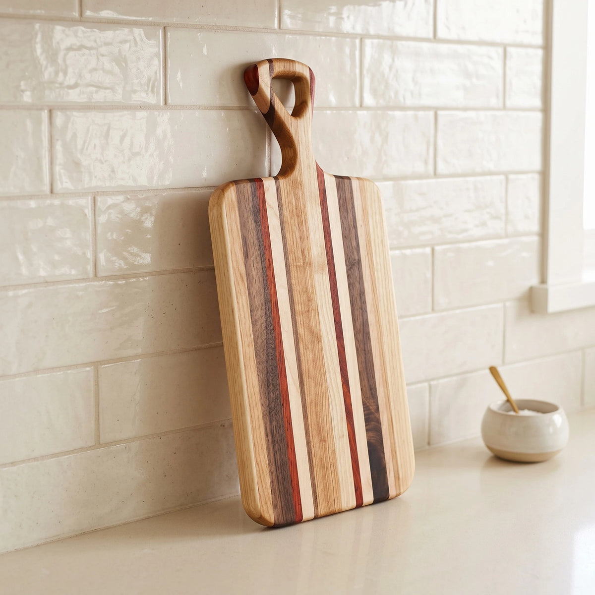 Edge grain charcuterie board made from mixed hardwoods, 16 by 7 inches